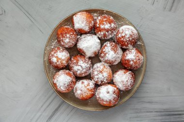 Tabakta pudra şekerli ev yapımı kızarmış donut delikleri..