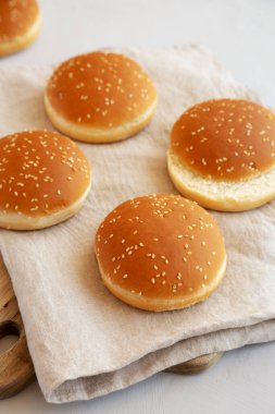 Tahta üzerinde klasik susam tohumlu hamburger çörekleri, yan manzara..