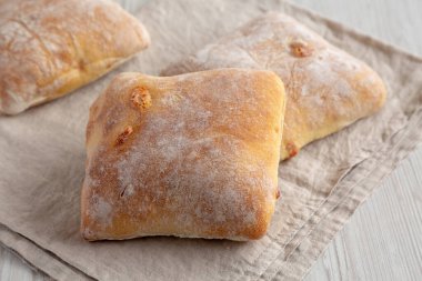 Beyaz ahşap arka planda ev yapımı Cheese Ciabatta çörekleri..