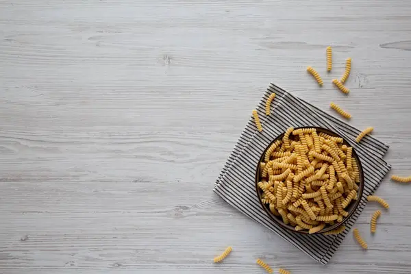 Stock image Raw Dry Organic Italian Fusilli Corti Bucati in a Bowl, top view. Copy space.