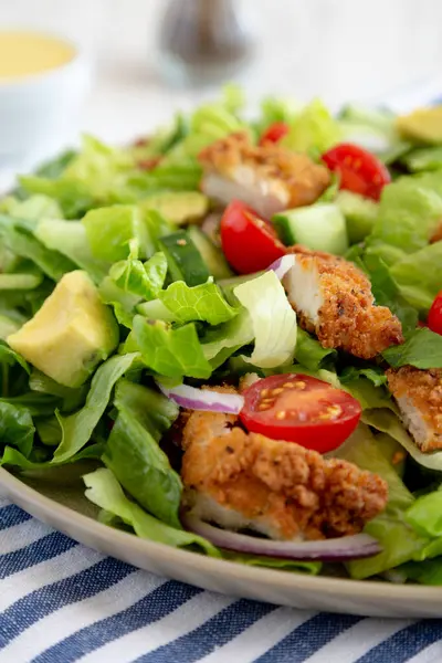 stock image Homemade Crispy Chicken Salad with Tomato and Cucumber on a Plate, side view. Close-up.