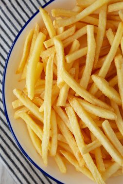 Homemade American French Fries on a Plate, top view. Close-up. clipart