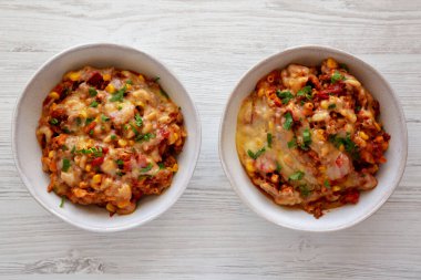 Homemade One-Pot Cheesy Taco Pasta in Bowls, top view. Overhead, flat lay, from above. clipart