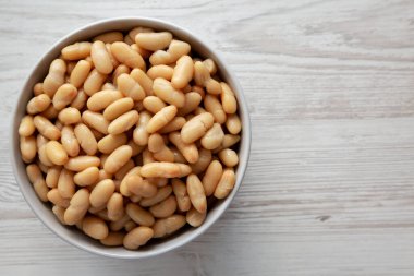 Canned White Cannellini Beans in a Bowl, top view. Copy space. clipart