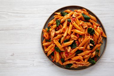 Homemade One-Pot Spinach And Tomato Pasta on a Plate, top view. Copy space. clipart