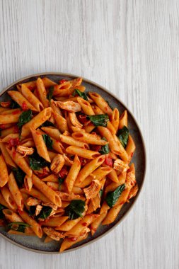 Homemade One-Pot Spinach And Tomato Pasta on a Plate, top view. Copy space. clipart