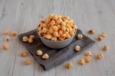 Homemade Crunchy Chicago-Style Popcorn with Caramel and Cheese in a Bowl, side view. clipart