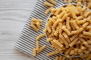 Fırında pişmemiş organik fusilli makarna, en iyi görüntü. Dümdüz, tepeden, yukarıdan.