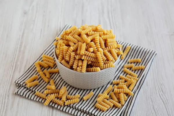 Pişmemiş Organik Kuru Fusilli Makarna Bir kâsede, yan görünüm.