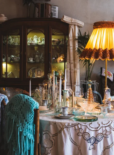 Vintage interior. Wooden retro furniture. Glassware on table.