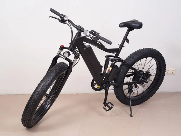 stock image Modern black bicycle with thick wheels and an electric motor.