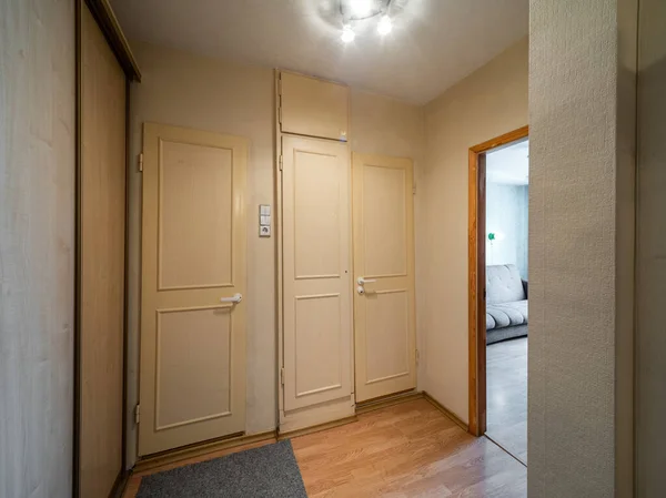Modern interior of hall in apartment. Closed white doors