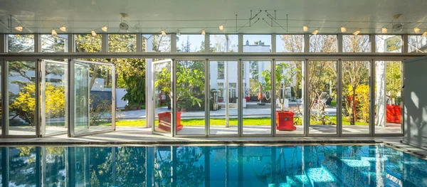 stock image Modern interior of luxury private house. Swimming pull in cottage. Glass wall.