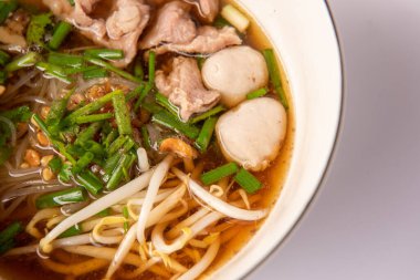 Domuz etli erişte ve Tayland usulü beyaz kasede çorba.