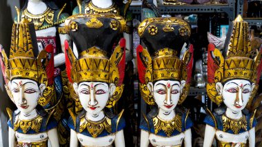 Dewi Sri wooden statues as souvenir on display for sale in Bali, Indonesia.  clipart