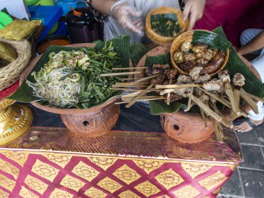 Indonesian spiced meat satay skewers usually served on banana leaf.Bamboo sticks hold the meat, which is uniformly aligned. The banana leaf serves as a decorative and functional base. Bali, Indonesia, August 2025