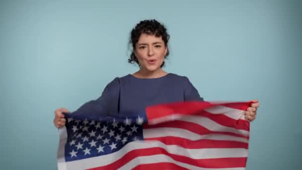 Sonriente Mujer Rizada Suéter Azul Con Bandera Americana Cámara Dice — Vídeo de stock