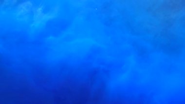 Slow motion blue ink acrylic paint mixing in water, swirling softly underwater. Colored acrylic cloud of paint isolated. Abstract smoke explosion animation. Slowmotion beautiful art background