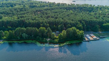 Aerial view summer forest and river in sunny day. Drone shot beautiful nature landscape, green trees