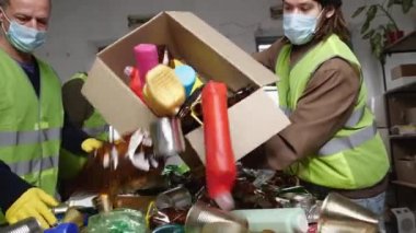 Workers Materials Recovery Facility sort recyclable waste into paper plastics metal glass and other types of material. . High quality 4k footage