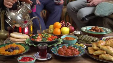 Ramadan Celebrating. Muslim family around the table. Traditional festive islamic halal meals and food. High quality 4k footage