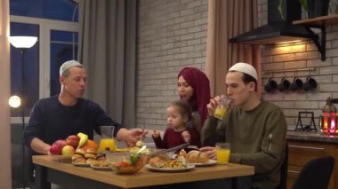 Authentic Muslim family having dinner together. Iftar during Ramadan. Eating together. High quality 4k footage