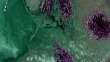 Stream of green pink and glitter silver liquid metallic ink. Texture of paint macro. Abstract background. Motion mixed colourful fluid art. High quality 4k footage