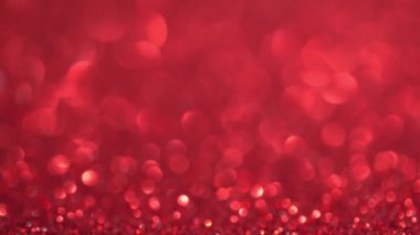 Parlak kırmızı yüzey dönüyor. Sihirli bokeh arka planı. Yüksek kalite 4k görüntü