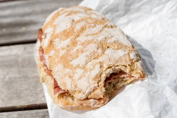 Bitten ham sandwich with rustic bread