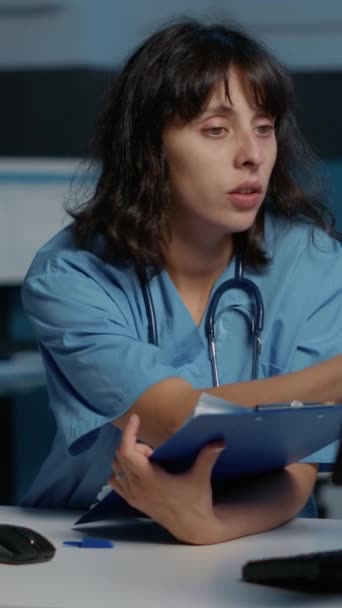 Vídeo Vertical Enfermera Médica Revisando Informe Enfermedad Computadora Mientras Trabaja — Vídeo de stock