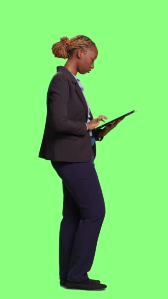 垂直视频 现代女商人在绿屏背景下使用平板电脑 全身绿屏 用触摸屏在数字小工具上浏览互联网 与无线现代设备一起工作 — 图库视频影像