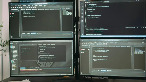 Desk with multiple monitors displaying terminal window and artificial intelligence programming code. Empty software developing agency office with servers cloud computing, html script.