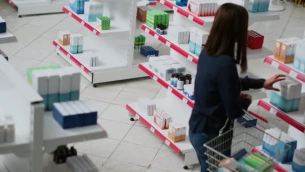 不同的人看货架上的药品 检查半成品 以购买处方药或维生素 药学客户分析补充剂包装 手持射击 — 图库视频影像