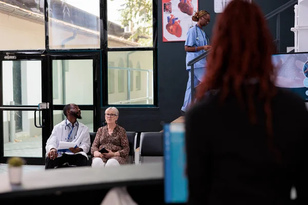 Doctor Sitting Hospital Waiting Area Showing Disease Report Senior Patient — Stock Photo, Image