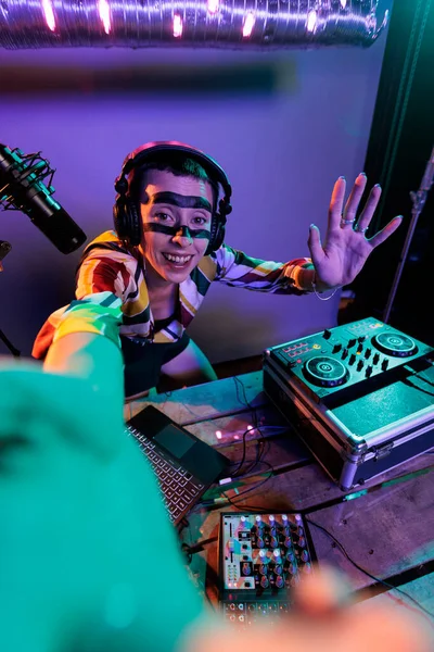 Female dj producer mixing sounds on turntables, using buttons and bass key to mix techno music. Musician artist performing with mixer at nightclub, using electric control panel, disc jockey.
