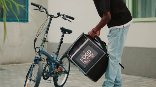 Αφρικανική Αμερικανική Μεταφορέας Ιππασία Ποδήλατο Για Δώσει Πακέτο Γεύμα Στον — Αρχείο Βίντεο