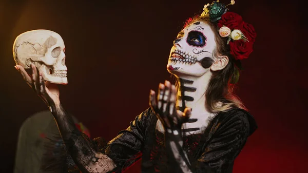Joven Dama Asustadiza Mirando Cráneo Estudio Vistiendo Disfraz Halloween Espeluznante — Foto de Stock