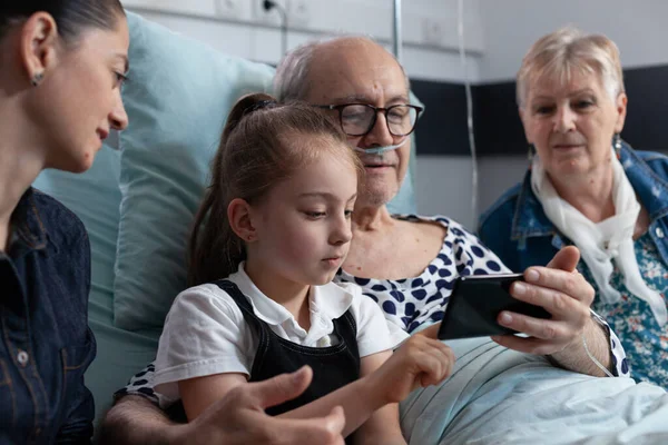 Jonge Kleindochter Grootvader Speelt Mobiele Telefoon Videospelletjes Liggend Sanatorium Bed — Stockfoto