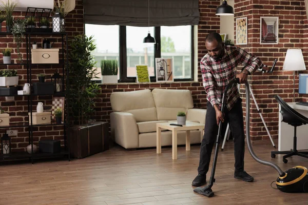 Single African American Man Doing House Cleaning Concentrating While Vacuuming — Stock Photo, Image