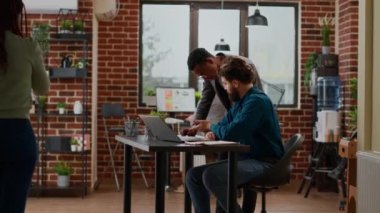 Team of coworkers analyzing data charts and graphs on papers, doing teamwork to create project report. People working on partnership presentation with business research in office.
