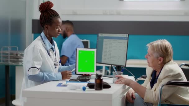 Doctor Patient Wheelchair Using Greenscreen Display Tablet Looking Chromakey Display — стоковое видео