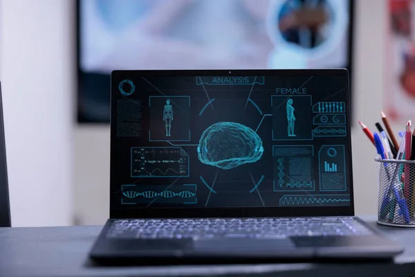 stock image Close up of laptop screen showing analysis results and health status of patient. Neurologist doctor computer on top of desk with pens at medical office in hospital. Brain scanner on notebook monitor.