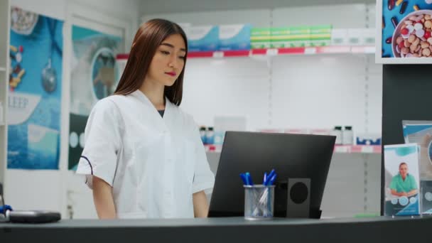 Asian Pharmacist Working Pharmaceutical Drugstore Shop Looking Prescription Computer Analyzing — Stock Video