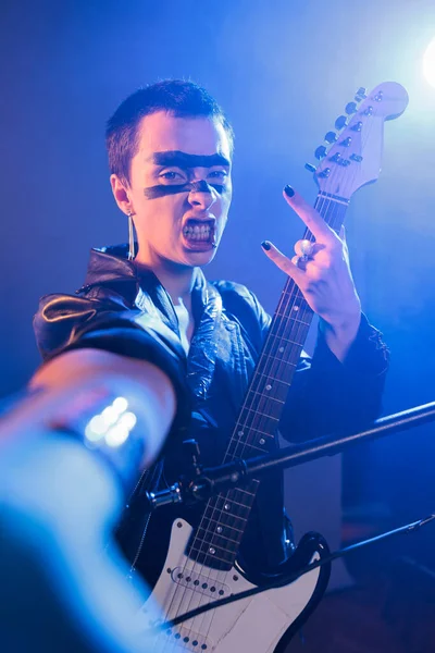 Playful Guitarist Showing Rock Sign Camera Playing Guitar Creating Musical — Stock Photo, Image