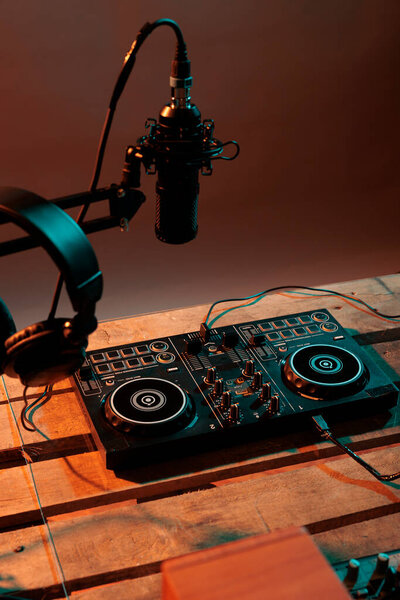 Musical production table with dj turntables and equipment, audio instrument with microphone and headphones. Electric vinyl used at nightclub to mix and listen to techno music, electronics.