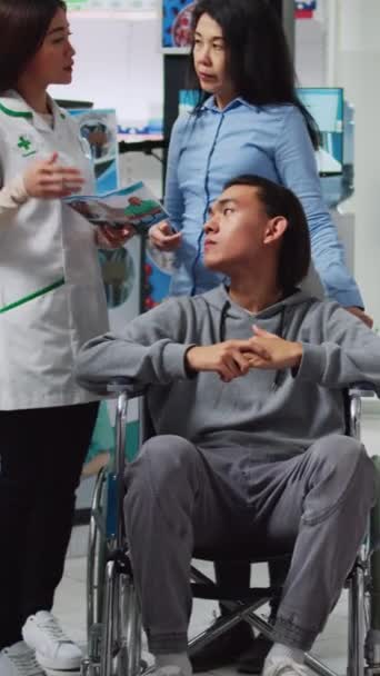 Vertical Video Young Man Wheelchair Social Worker Talking Pharmacist Looking — Stock Video