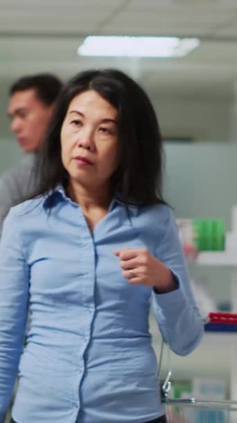 Dikey Video Sepet Taşıyan Vitamin Almak Isteyen Bir Kadın Müşteri — Stok video