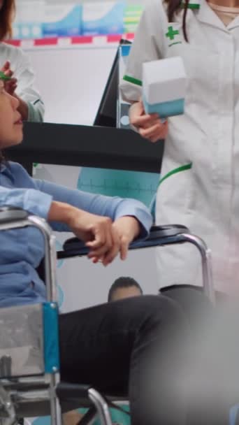 Pionowe Wideo Kobieta Wózku Inwalidzkim Otrzymuje Pomoc Farmaceuty Poszukuje Witamin — Wideo stockowe