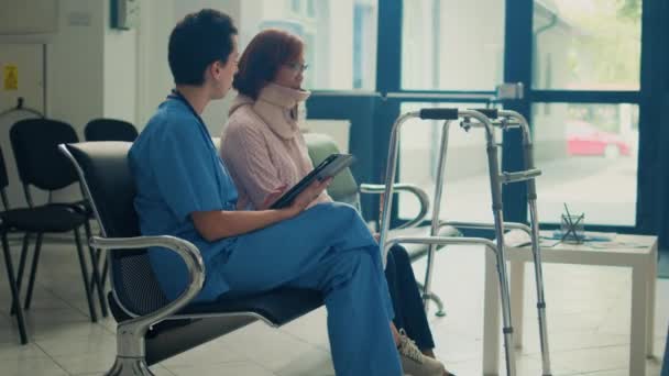 Vrouwelijke Verpleegster Gesprek Met Aziatische Patiënt Met Een Halsband Nek — Stockvideo