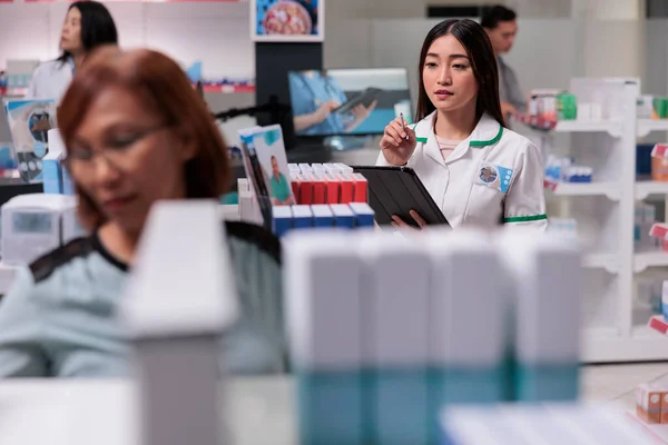 Asian Pharmacist Working Drugstore Help Clients Analyzing Medical Products Digital — Stock Photo, Image